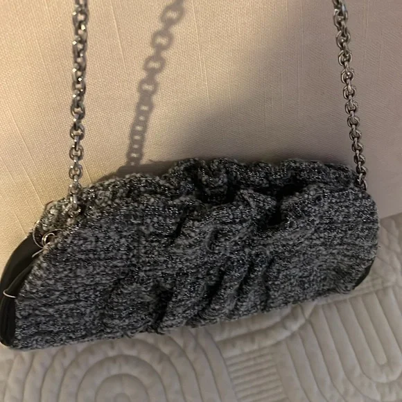 Shades of woven gray, and silver and black leather trim.Removable silver chain